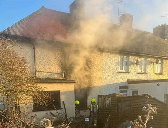 A home billowing with smoke from a halogen heater fire last year. Photo by Essex County Fire and Rescue Service