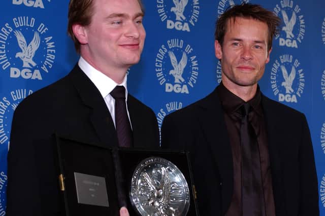 British director Christopher Nolan (L) poses backstage with his nomination medal for Best Feature Film Director for "Memento," with Australian actor Guy Pearce (R), who starred in the film, at the 54th Annual Directors Guild Awards in Los Angeles, CA, 09 March 2002.   (AFP PHOTO/Lucy NICHOLSON)