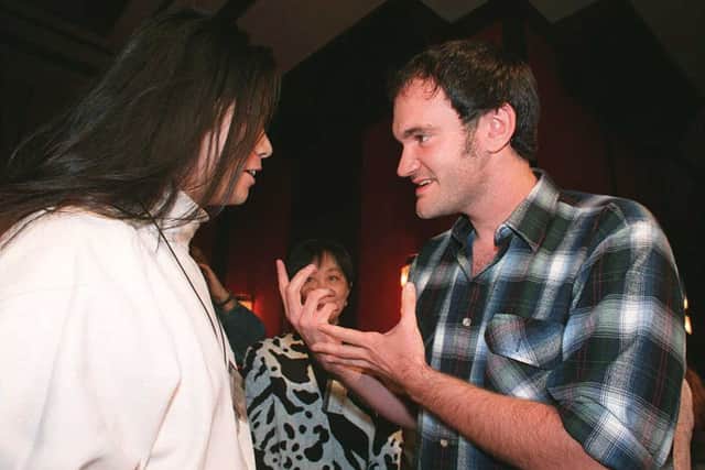 American film director Quentin Tarantino ("Pulp Fiction") (R) discusses the trade with Chinese director Sherwood Xuehua Hu ("Warrior Lanling") 06 October at a press conference of the Sundance Film Festival in Beijing. (STR/AFP via Getty Images)