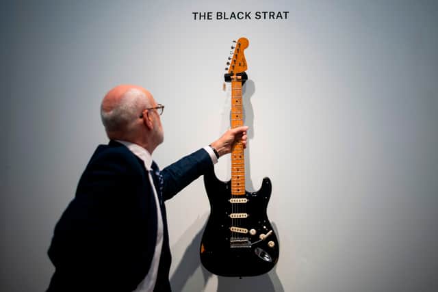 Kerry Keane, Christie's Musical Instruments Specialist holds the "Black Strat" (Fender Stratocaster, 1969) from David Gilmour at Christie's on June 14, 2019 in New York City. Picture: Getty
