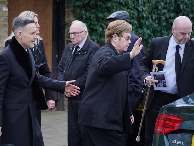Sir Elton John and David Furnish leave the funeral service of Derek Draper at St Mary the Virgin church in Primrose Hill, north west London. Photo by Jonathan Brady/PA Wire