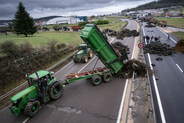 A farmer dumps agricultural waste to block the RN 19 near Vesoul in eastern France (Photo: SEBASTIEN BOZON/AFP via Getty Images)
