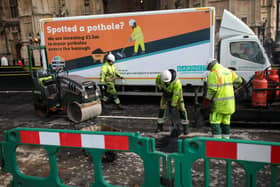 Roadworks are carried out and potholes are filled by workers in front of the Houses of Parliament. Picture: Jack Taylor/Getty Images
