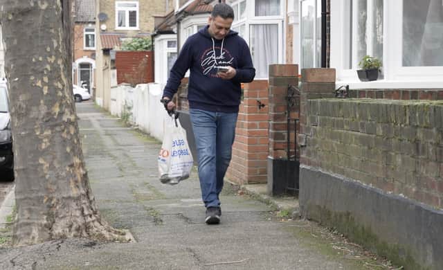 Suleman Chohan, 50, carrying shopping with his prosthetic hand. (Picture: Open Bionics / SWNS)