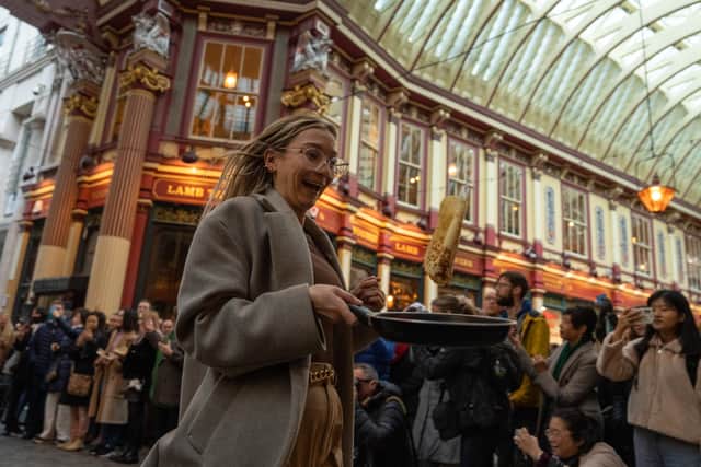 A woman takes part in a pancake race in Leadenhall Market (Photo: Carl Court/Getty Images)
