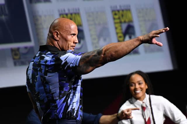 Actor Dwayne Johnson, with cast members, presents his film "Black Adam" during the Warner Bros. panel at Comic-Con in San Diego, California, July 23, 2022. (Photo by Chris Delmas / AFP) 