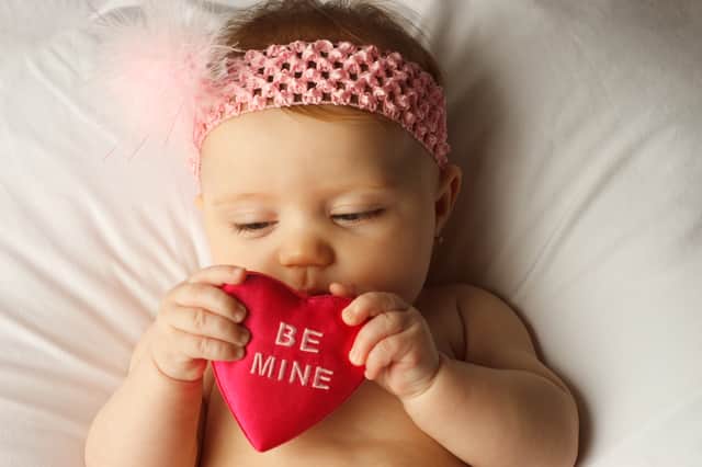 37 love themed boys, girls and gender neutral baby names inspired by Valentine's Day. Stock image by Adobe Photos.