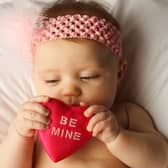 37 love themed boys, girls and gender neutral baby names inspired by Valentine's Day. Stock image by Adobe Photos.