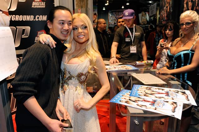 Attendee Ed Teng (L) of Nevada takes a photo with adult film actress Jesse Jane at the Digital Playground booth at the 2010 AVN Adult Entertainment Expo at the Sands Expo and Convention Center January 9, 2010 in Las Vegas, Nevada.  (Photo by Ethan Miller/Getty Images)