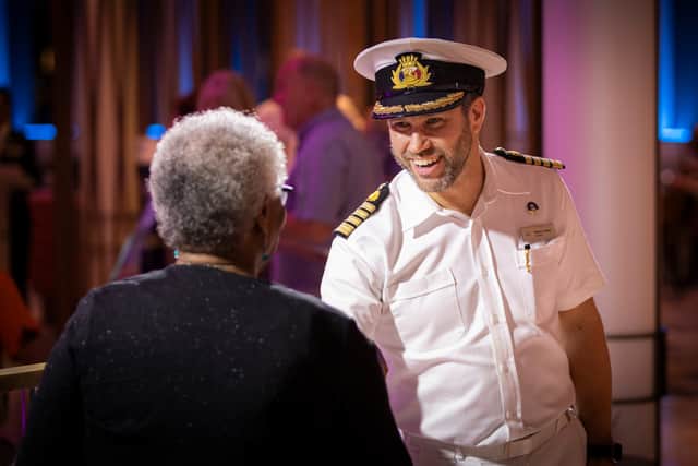 Captain Robert Camby meeting guests in the Atrium on Arvia