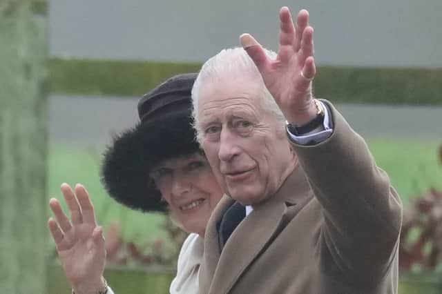King Charles III and Queen Camilla wave to well wishers after attending a Sunday church service at St Mary Magdalene Church in Sandringham, Norfolk.