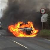 Jodie Buckley's Suzuki Swift on fire. The vehicle first started smoking and then went up in flames when she was driving to visit her mum. Photo by Jo Buckley / SWNS.
