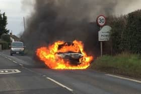 Jodie Buckley's Suzuki Swift on fire. The vehicle first started smoking and then went up in flames when she was driving to visit her mum. Photo by Jo Buckley / SWNS.