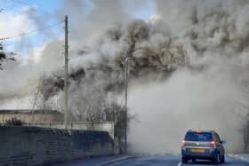 Plumes of smoke are engulfing Wesley Road, Armley, as firefighters respond to a building fire. Photo: Melanie Robbins.