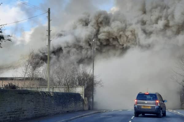 Plumes of smoke are engulfing Wesley Road, Armley, as firefighters respond to a building fire. Photo: Melanie Robbins.