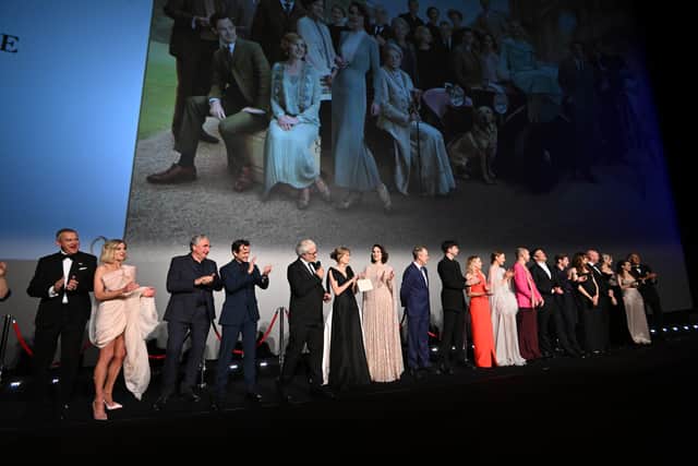 The cast stand on stage at at the world premiere of "Downton Abbey: A New Era" at Cineworld Leicester Square on April 25, 2022 in London, England. (Photo by Jeff Spicer/Getty Images for Focus Features, UNIVERSAL Pictures And Carnival Films )