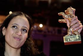 French-Senegalese filmmaker and actress Mati Diop poses with the Golden Bear for Best Film for the film "Dahomey" on the red carpet after the awards ceremony the 74th Berlinale International Film Festival, on February 24, 2024  in Berlin. (Photo by Tobias SCHWARZ / AFP