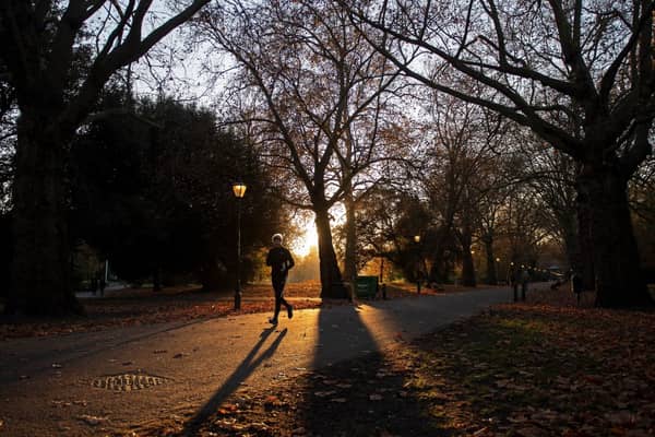 Professor Robert Thomas's tips on how to beat your Personal Best on a Park Run. A person runs through an autumnal evening sunset in Battersea Park in south London on November 23, 2021. (Photo by Justin TALLIS / AFP) (Photo by JUSTIN TALLIS/AFP via Getty Images)
