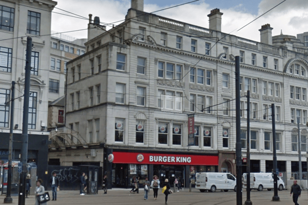 A fire has broken out at a building above Burger King at Piccadilly Gardens in Manchester city centre