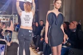 Victoria Beckham's show at Paris Fashion Week was targeted by an activist