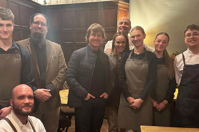 Tom Cruise stands beside staff at Restaurant Lovage in Bakewell, Derbyshire, after dining there on March 5 2024.  Restaurant Lovage / SWNS