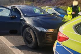 Police surround an electric car after its brakes failed on the M62 and the driver could not stop