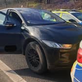 Police surround an electric car after its brakes failed on the M62 and the driver could not stop