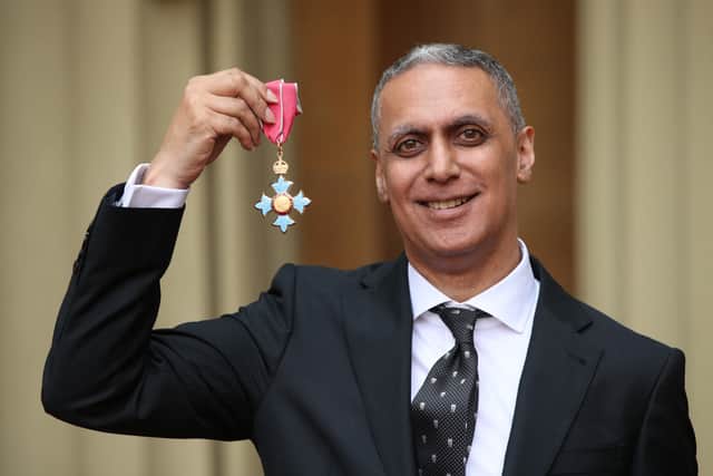 British musician Nitin Sawhney poses with his medal and insignia after he was appointed a Commander of the Order of the British Empire (CBE) by Britain's Prince Charles, Prince of Wales for services to music, at an investiture ceremony at Buckingham Palace in London on May 9, 2019. (Photo by Yui Mok / POOL / AFP)