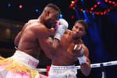 Anthony Joshua punches Francis Ngannou during their heavyweight fight in the Kingdom Arena in Riyadh, Saudi Arabia. 