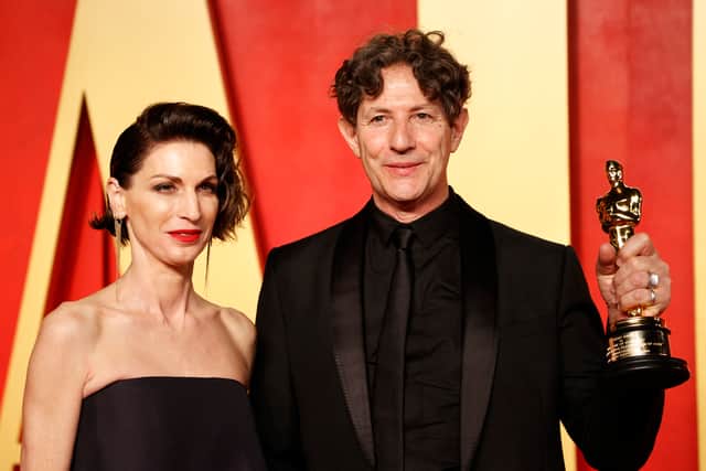 English director Jonathan Glazer (R) poses with the award for Best International Feature Film for "The Zone of Interest" as he attends the Vanity Fair Oscars Party at the Wallis Annenberg Center for the Performing Arts in Beverly Hills, California, on March 10, 2024. (Photo by Michael TRAN / AFP)