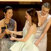  Emma Stone (2nd R) accepts the Best Actress in a Leading Role award for "Poor Things" from Jennifer Lawrence, Michelle Yeoh, and Charlize Theron onstage during the 96th Annual Academy Awards at Dolby Theatre on March 10, 2024 in Hollywood, California. (Photo by Kevin Winter/Getty Images)