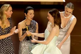  Emma Stone (2nd R) accepts the Best Actress in a Leading Role award for "Poor Things" from Jennifer Lawrence, Michelle Yeoh, and Charlize Theron onstage during the 96th Annual Academy Awards at Dolby Theatre on March 10, 2024 in Hollywood, California. (Photo by Kevin Winter/Getty Images)