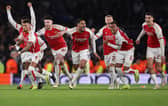 Arsenal celebrate reaching the last eight of the UEFA Champions League