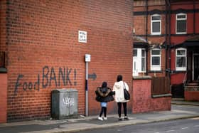 A sign painted on the side of a house directs people to a local food bank in Leeds (Photo: Christopher Furlong/Getty Images)