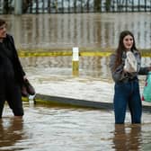 A rain bomb is expected to hit over Easter Bank Holiday weekend. People walk through a flooded street in Worcester City Centre on January 03, 2024 in Worcester, England