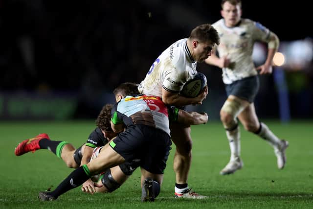 Jarrod Evans and Dino Lamb-Cona of Harlequins tackl Theo Dan of Saracens during the Gallagher Premiership Rugby match between Harlequins and Saracens at The Stoop on November 18, 2023 in London, England. (Photo by Tom Dulat/Getty Images)