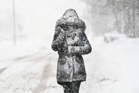 The Met Office has issued a yellow weather warning as snow and rain is set to hit the UK. A woman makes her way through the snow on March 1, 2018 in Balloch, Scotland