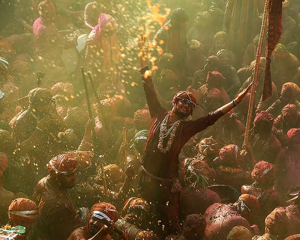 Revellers daubed in colours take part in Lathmar Holi celebrations, the Hindu spring festival of colours, at Nandgaon in India's Uttar Pradesh state on March 19, 2024. (Photo by AFP) 