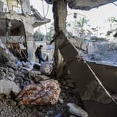 RAFAH, GAZA - MARCH 25: People inspect damage and recover items from their homes following Israeli air strikes on March 25, 2024 in Rafah, Gaza. 