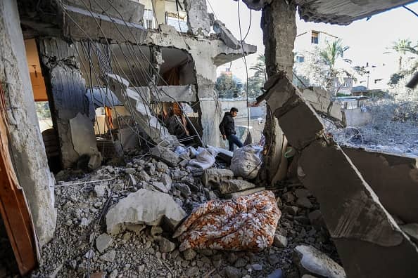 RAFAH, GAZA - MARCH 25: People inspect damage and recover items from their homes following Israeli air strikes on March 25, 2024 in Rafah, Gaza. 