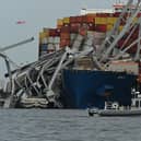 The steel frame of the Francis Scott Key Bridge sits on top of the container ship Dali after the bridge collapsed (Photo: ROBERTO SCHMIDT/AFP via Getty Images)