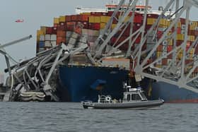 The steel frame of the Francis Scott Key Bridge sits on top of the container ship Dali after the bridge collapsed (Photo: ROBERTO SCHMIDT/AFP via Getty Images)