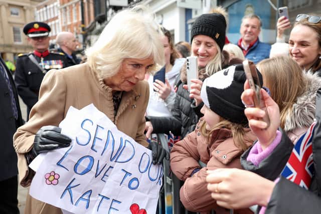 Queen Camilla receives a message of support for the Princess of Wales from well-wishers during a visit to the Farmers' Market in The Square, Shrewsbury, in Shropshire. Chris Jackson/PA Wire