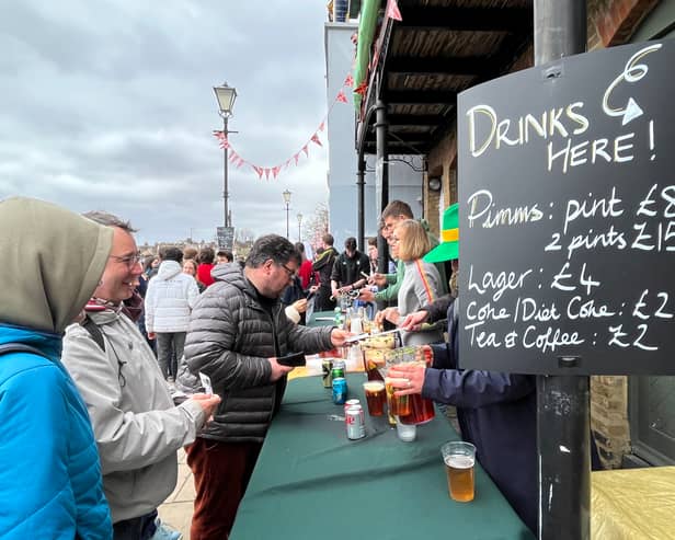 Furnivall Sculling Club members sell drinks at The Boat Race 2023.