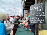 Furnivall Sculling Club members sell drinks at The Boat Race 2023.
