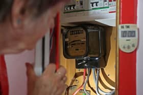 An energy customer examines their electricity meter (Photo: SUSANNAH IRELAND/AFP via Getty Images)