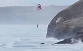 Dramatic moment dog walker rescued from sea in Cottys Point in Perranporth, Cornwall. Steve Finney / SWNS