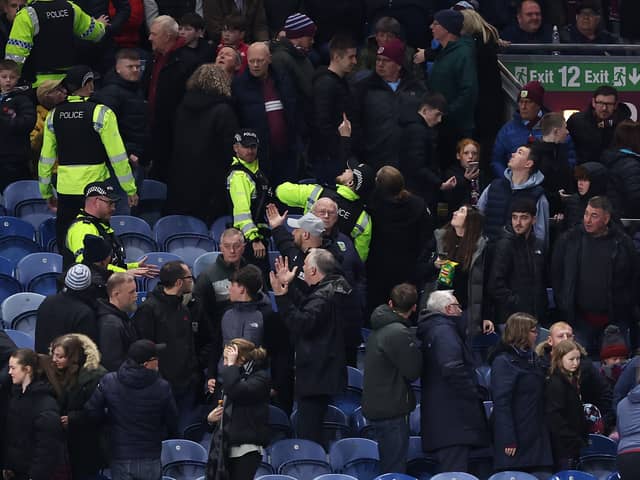 A number of Burnley fans were moved to the fan zone to watch the remainder of the game due to safety concerns.