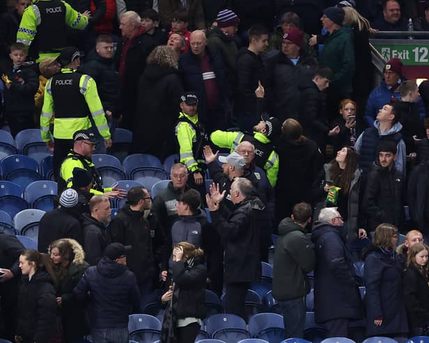 A number of Burnley fans were moved to the fan zone to watch the remainder of the game due to safety concerns.