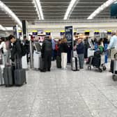 Passengers wait in line at Terminal 5 of Heathrow Airport, London. A planned relaxation of rules around airline passengers carrying liquids in hand luggage has been delayed by a year Picture: Jordan Pettitt/PA Wire